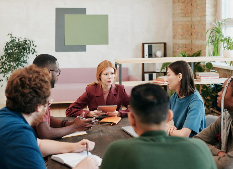 Group of people having a meeting in a bright open office